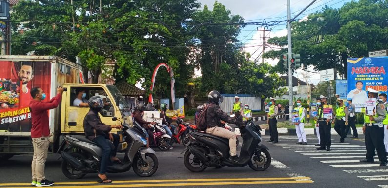 Satlantas Polres Badung Bagikan Masker, Saat Menggelar Operasi Keselamatan Agung 2021.